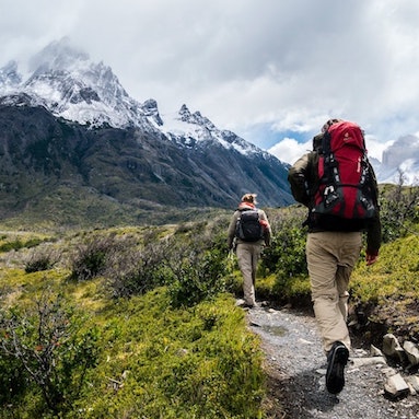 2 people hiking to a mountain